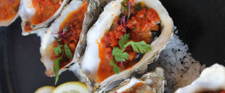 Grilled Oysters In A Chipotle, Bacon And Onion Butter